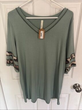 Celeste Sage Green V-Neck Tunic with animal print Sleeve Bands. NWT